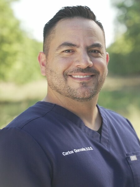 Dr. Carlos Quezada smiling, general dentist at My Hometown Dentist in professional headshot